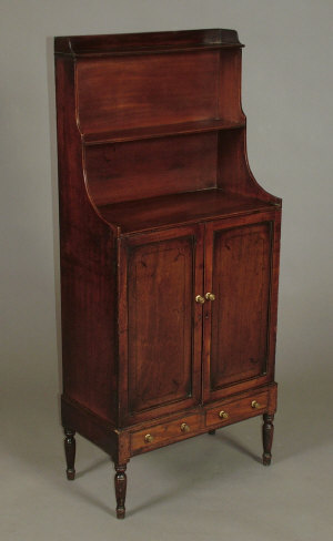 Appraisal: A Regency mahogany and ebony inlaid waterfall bookcase cupboard the