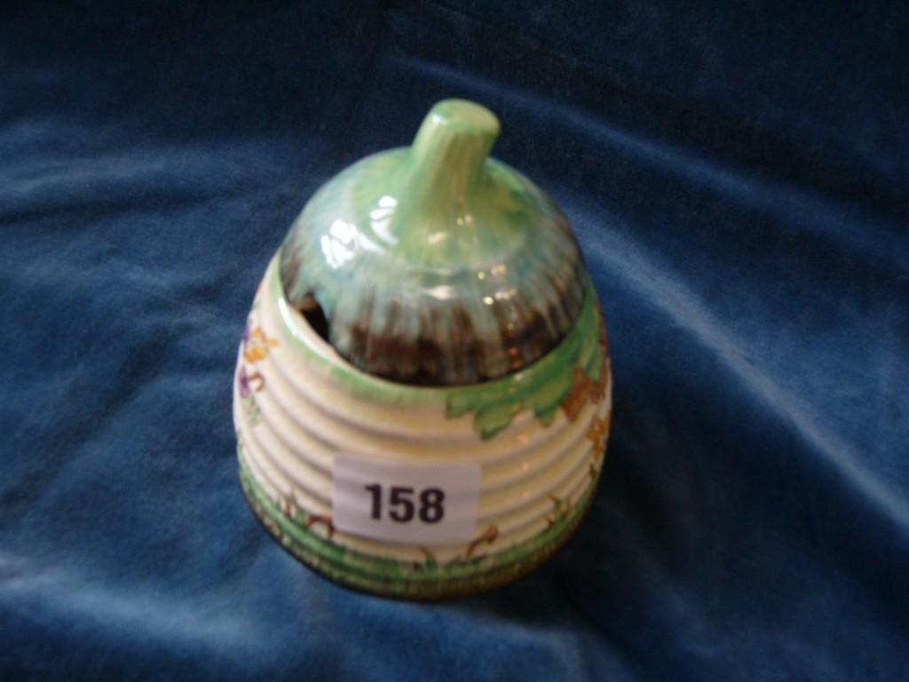 Appraisal: A Clarice Cliff honey pot and cover modelled as a