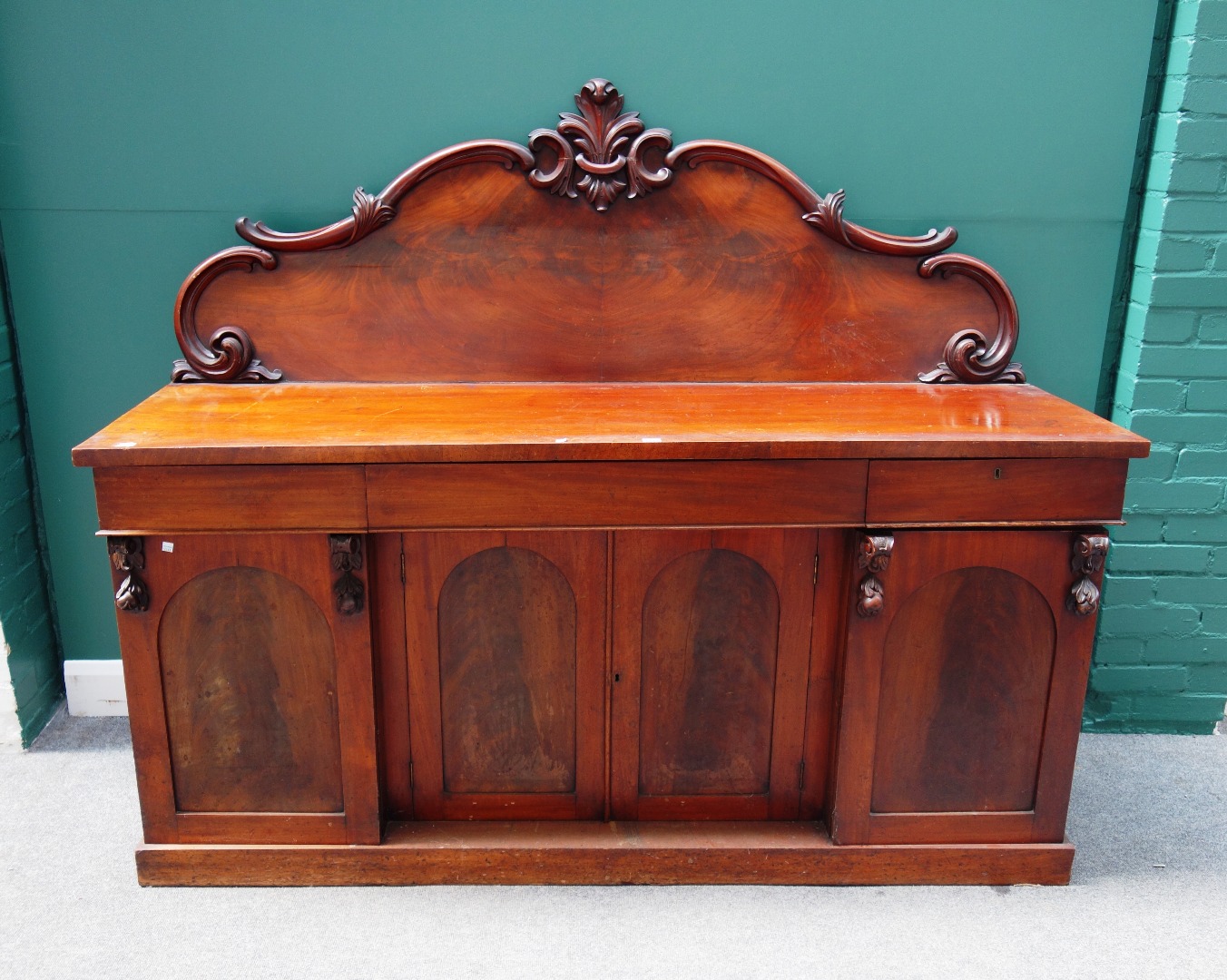 Appraisal: A th century mahogany sideboard the carved back over three