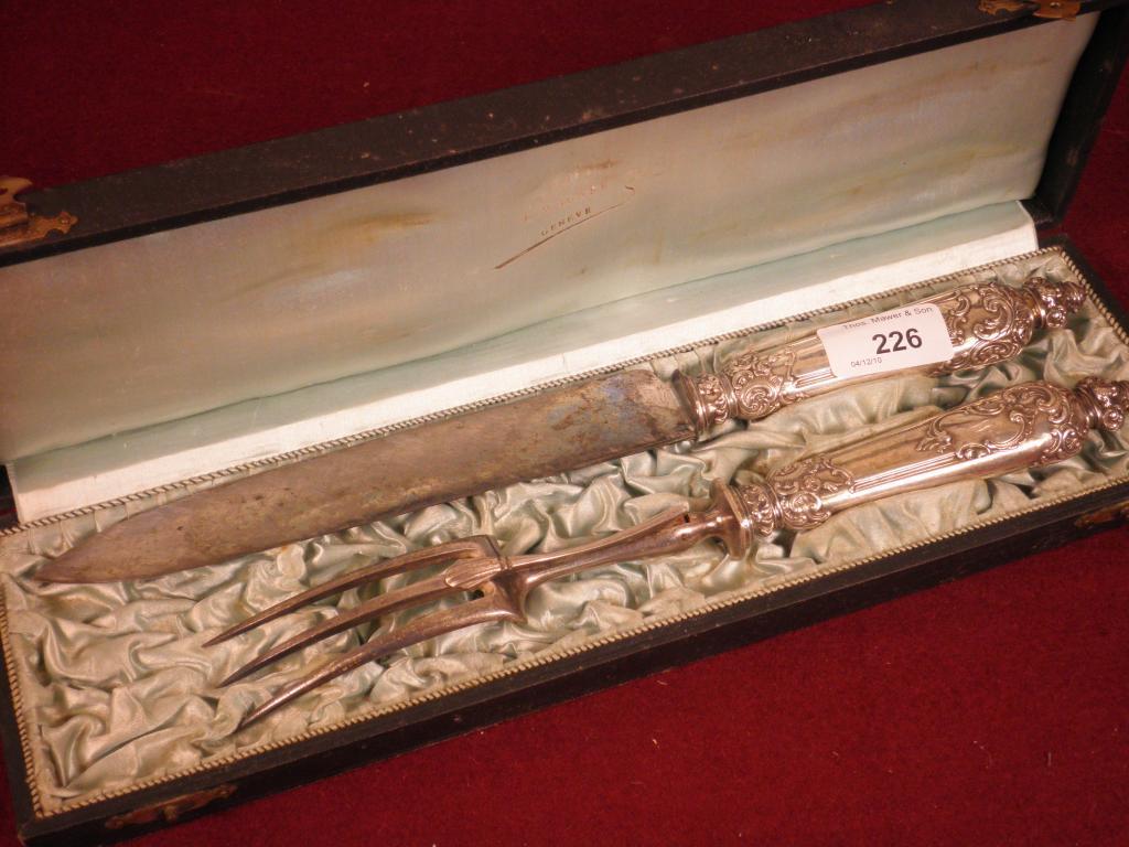 Appraisal: A Continental white meal carving set engraved with rococo scrolls