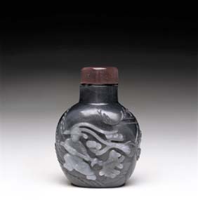 Appraisal: BLACK JADE SNUFF BOTTLE Superbly carved and finely hollowed Chinese