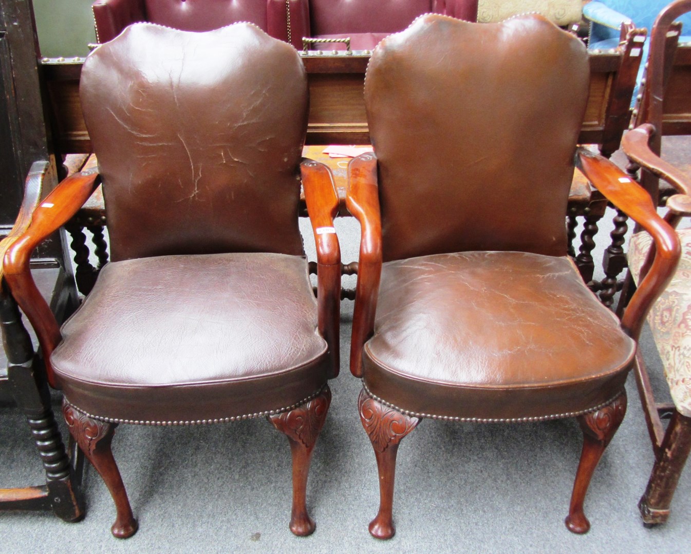 Appraisal: A pair of George I style leather upholstered stained beech