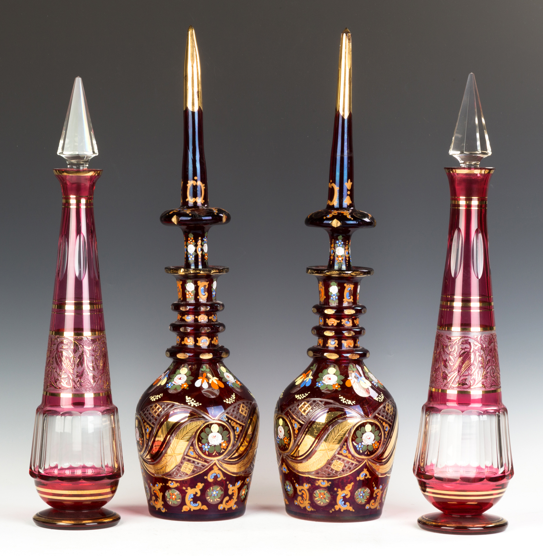 Appraisal: Pair Bohemian Decanters Late th century Outer-Cranberry overlay small chip