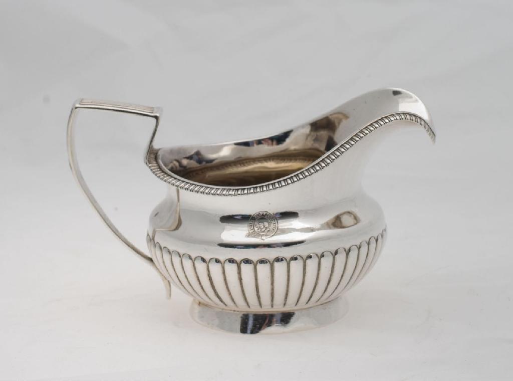 Appraisal: GEORGE III SILVER CREAM JUG LONDON with half-reeded body and