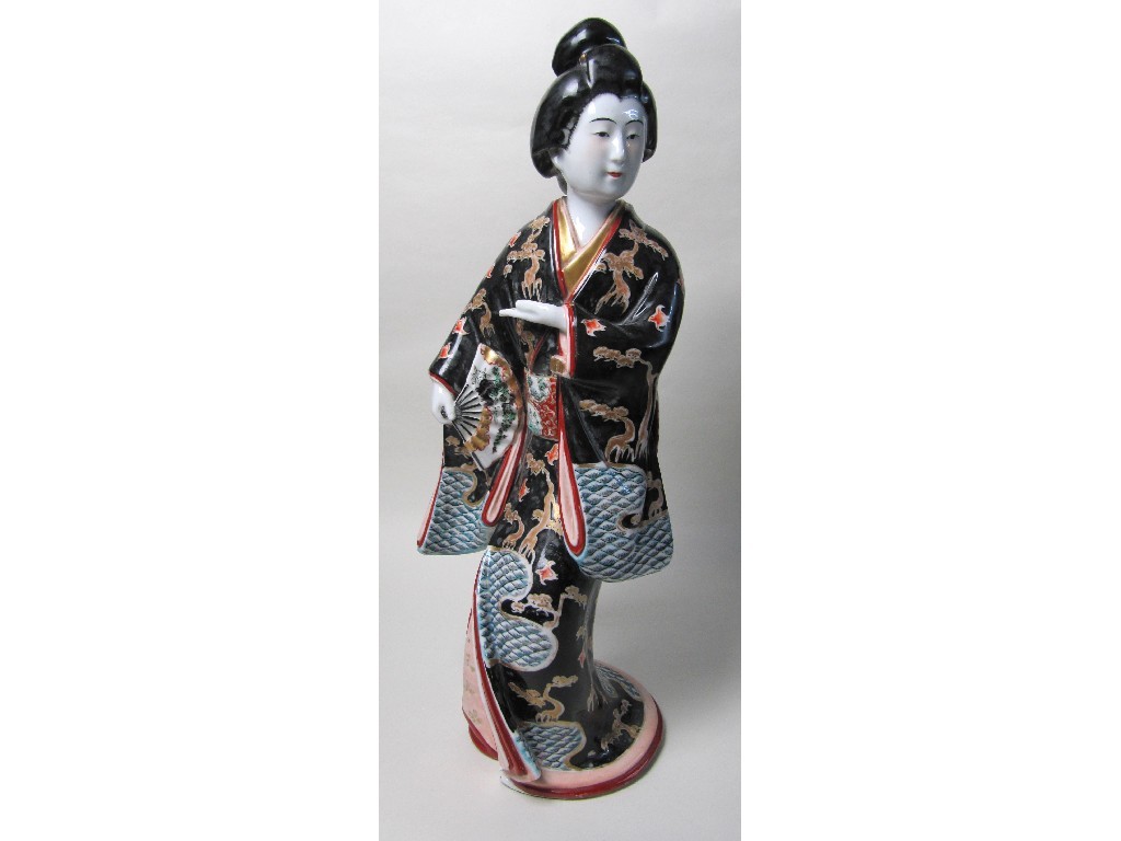 Appraisal: An Arita bejin standing in a theatrical pose holding a