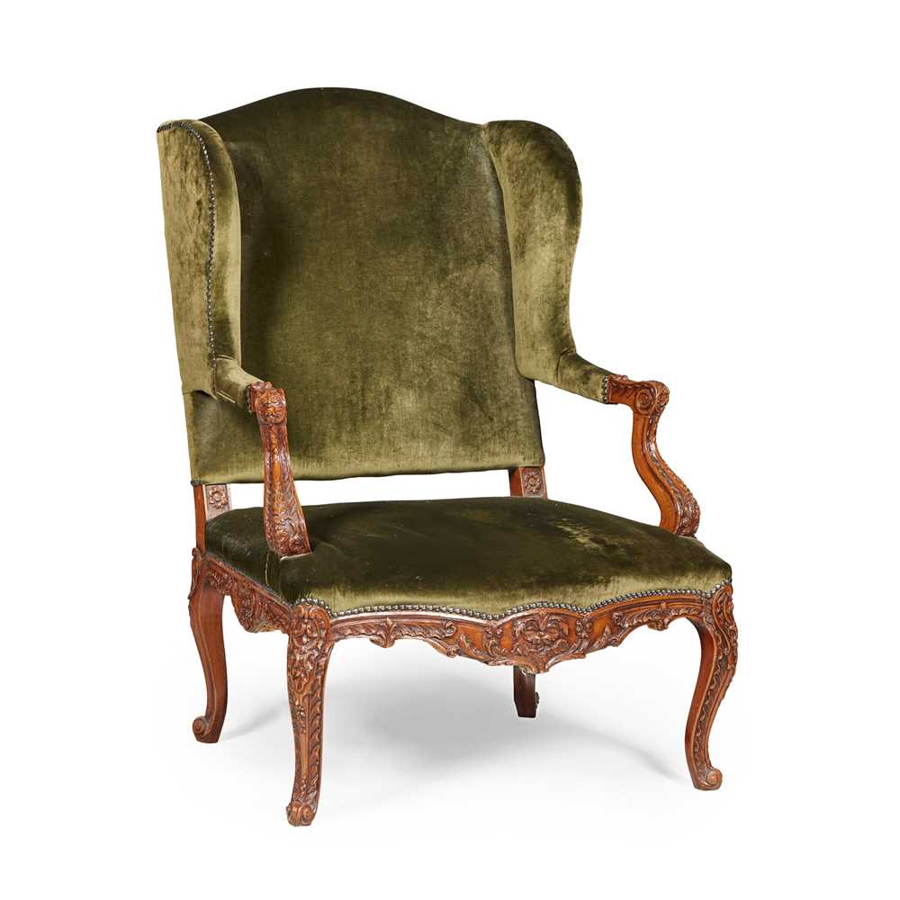 Appraisal: FRENCH BEECH WING ARMCHAIR TH CENTURY the foliate carved frame