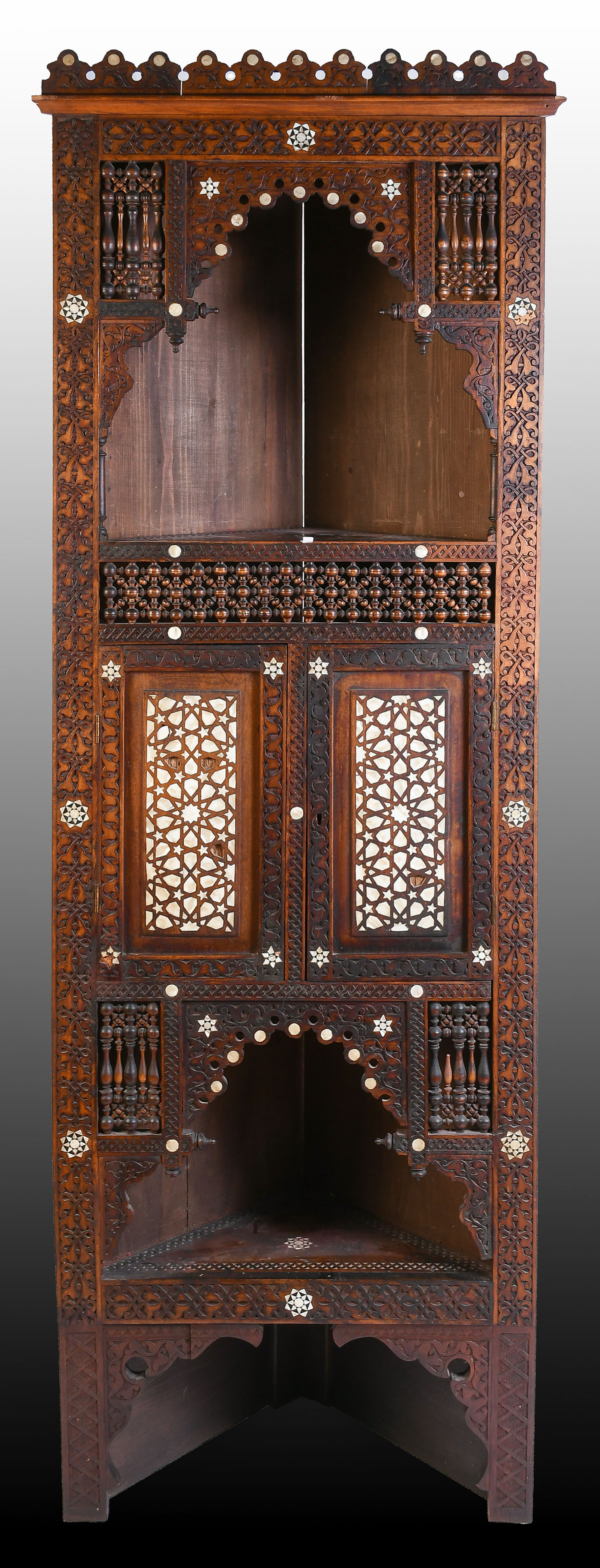 Appraisal: LATE TH-CENTURY MOORISH CARVED CORNER CABINET Profusely carved decoration inlaid