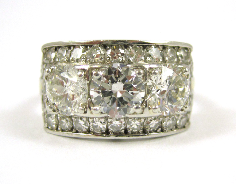 Appraisal: ESTATE DIAMOND AND PLATINUM RING with round-cut diamonds forming a