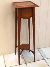 Appraisal: A stained oak and mahogany plant stand with undertier c