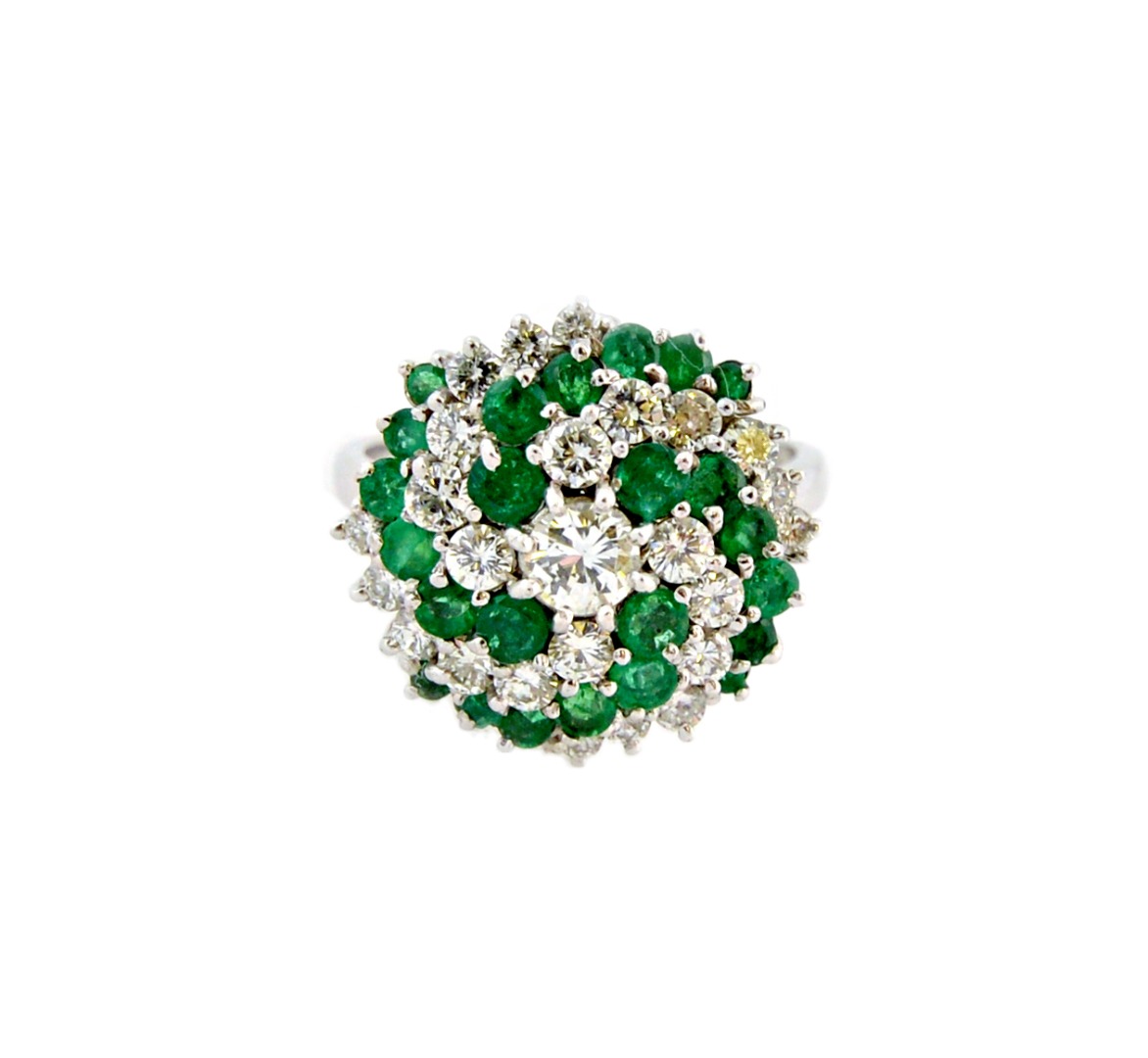 Appraisal: A white gold emerald and diamond circular cluster ring centred