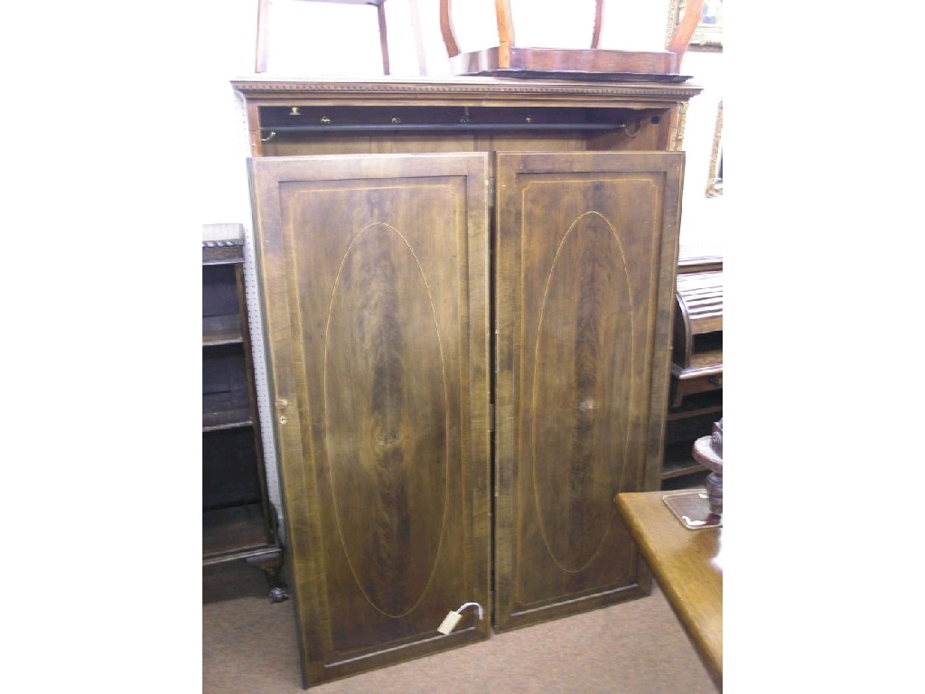 Appraisal: A small Edwardian inlaid mahogany gentleman's wardrobe enclosed by a