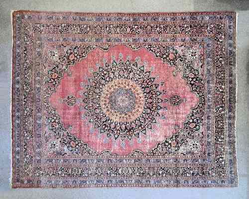 Appraisal: An Antique Meshad carpet woven in colours with medallion design