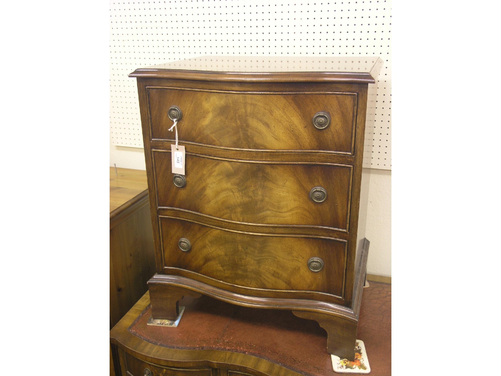 Appraisal: A Bevan Funnell Reprodux mahogany chest three serpentine-fronted drawers bracket