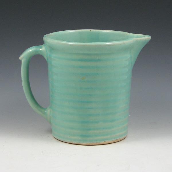 Appraisal: Weller utility pitcher with horizontal ridges in turquoise gloss glaze