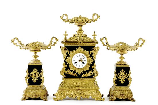 Appraisal: French slate and bronze-mounted clock garniture circa bronze tazza on