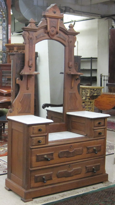 Appraisal: A VICTORIAN WALNUT DRESSER WITH TALL MIRROR American c featuring