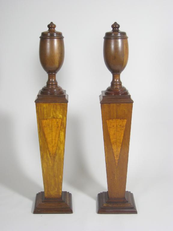 Appraisal: Pair of mahogany Urns and Covers on tapering pedestals with