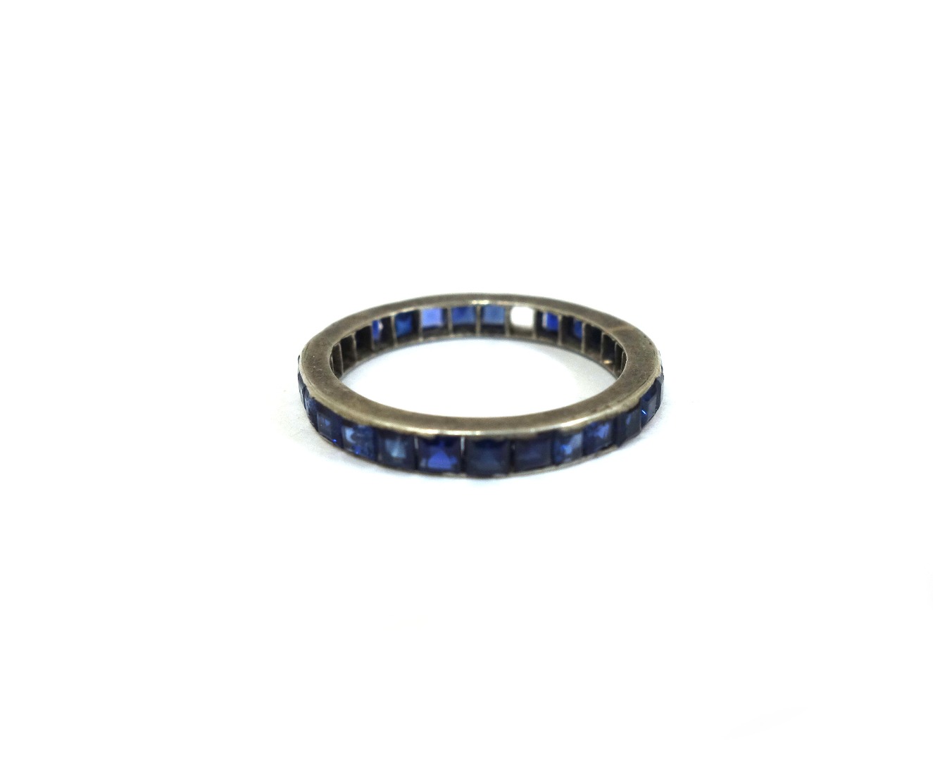 Appraisal: A sapphire eternity ring channel-set with calibre cut stones in