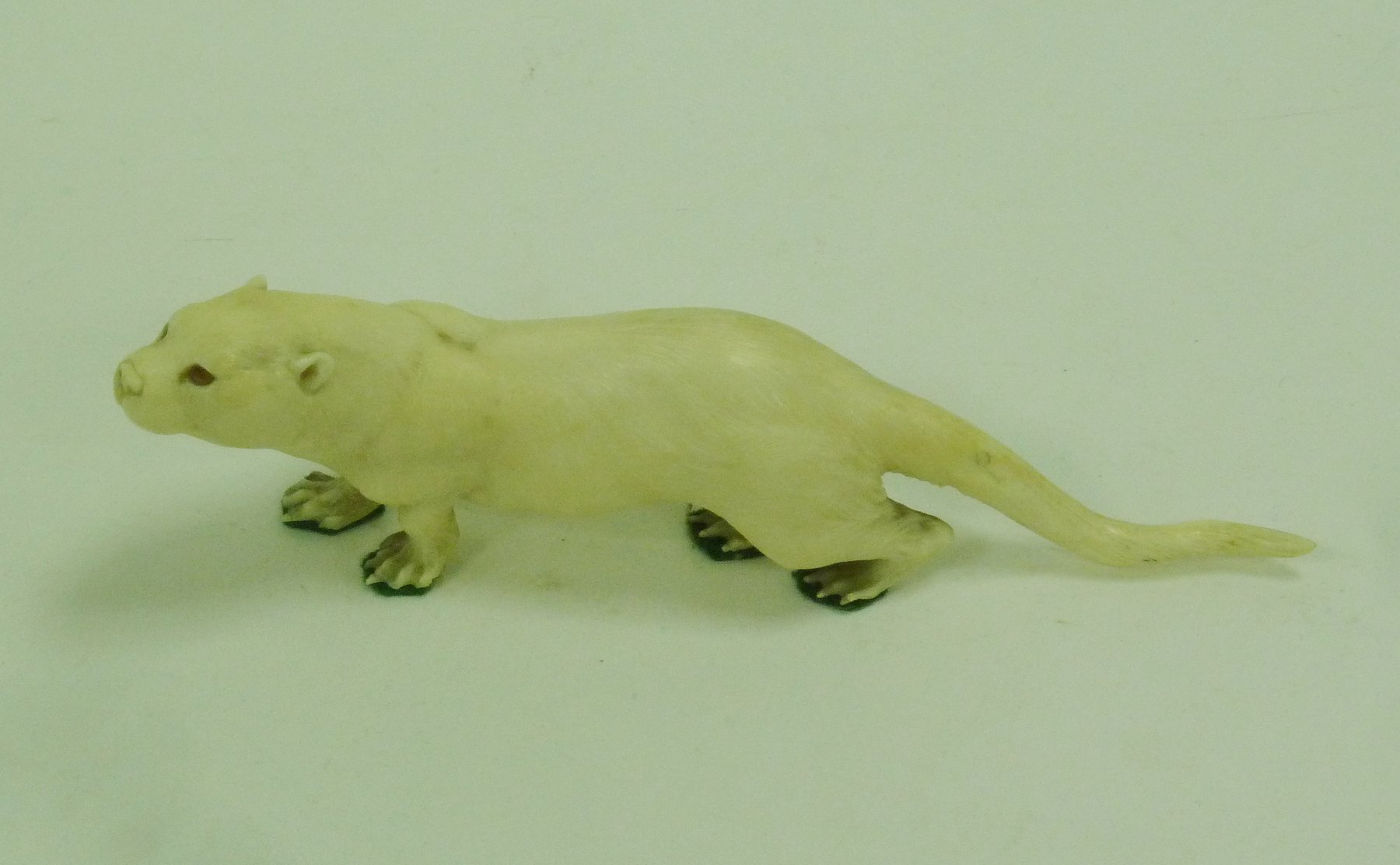 Appraisal: A Japanese carved ivory figure of an otter signed cm