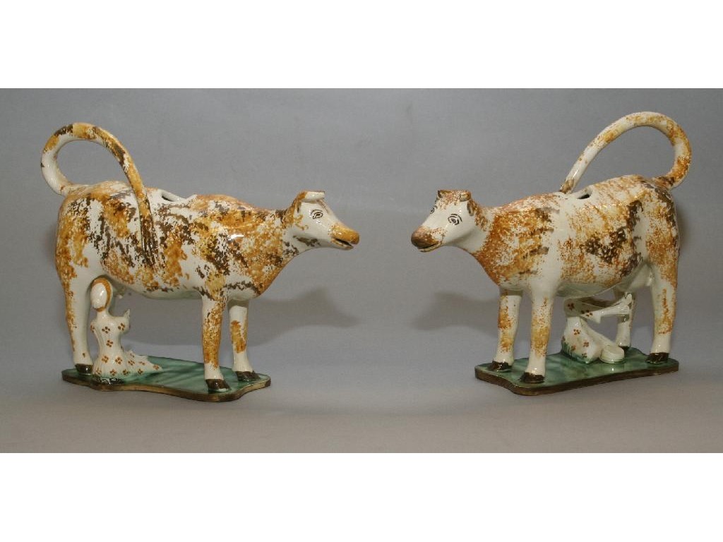 Appraisal: A pair of late th Century Staffordshire cow creamers each