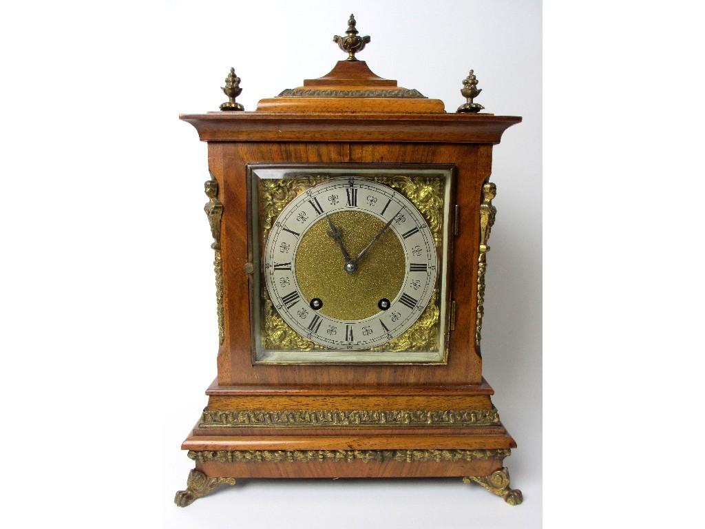 Appraisal: A German walnut cased mantel clock with silvered Roman numeral