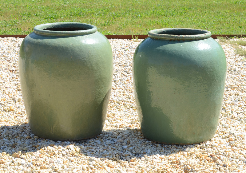 Appraisal: NEAR PAIR OF GREEN-GLAZED POTTERY JARDINI RES Each of ovoid