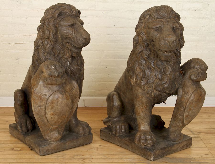 Appraisal: PAIR OF OPPOSING STONE SEATED LIONS A pair of opposing