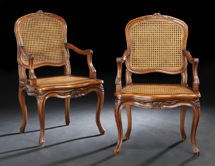 Appraisal: Pair of Provincial Louis XV-Style Fruitwood Fauteuils each with a