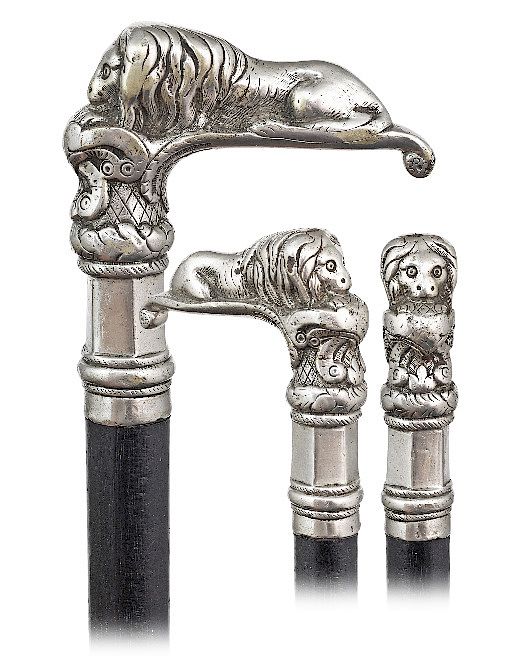 Appraisal: Lion Knobkerrie Cane -Ca -L-shaped and heavy cast white metal