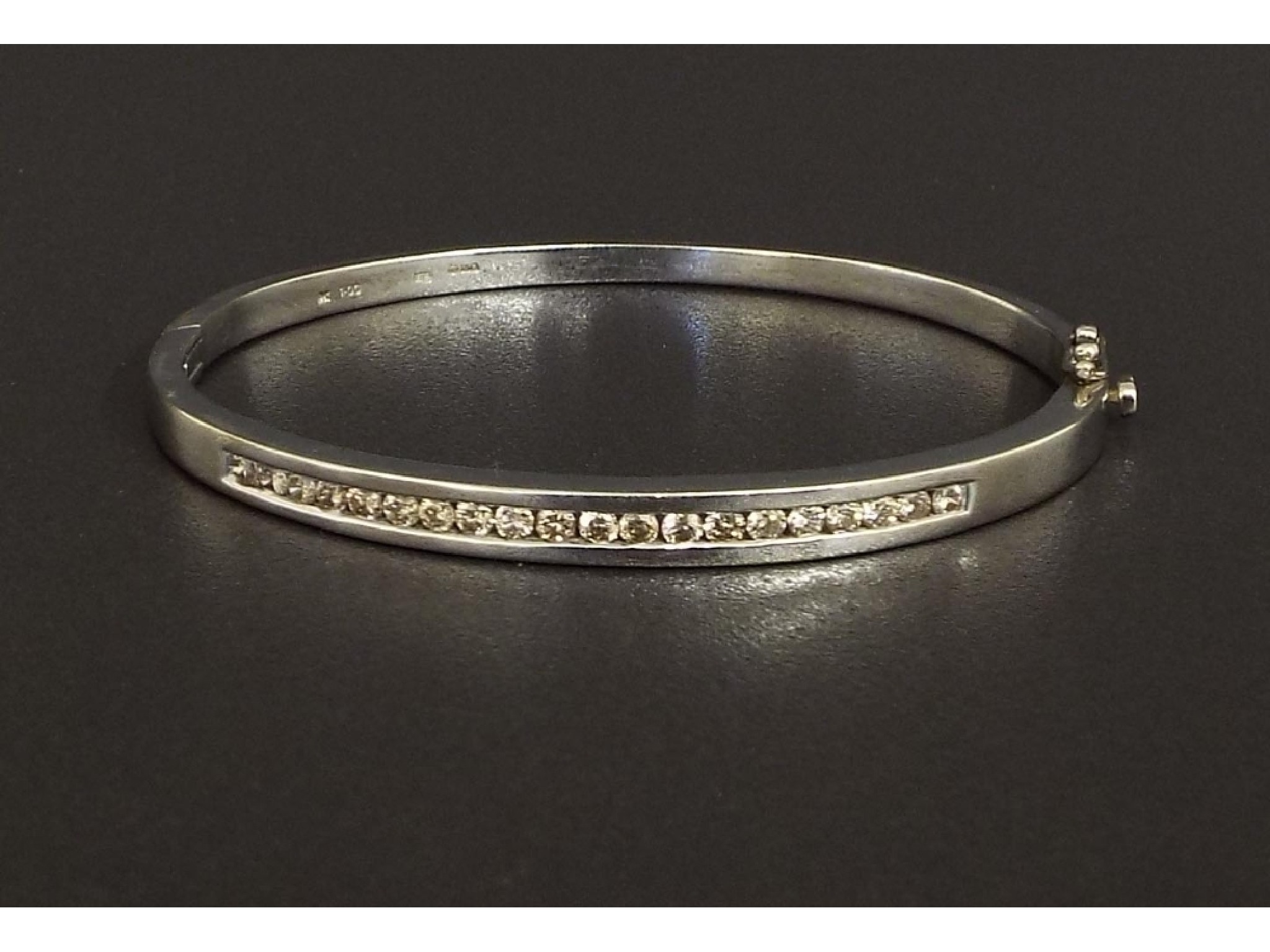 Appraisal: White gold diamond set bangle channel set with round brilliant