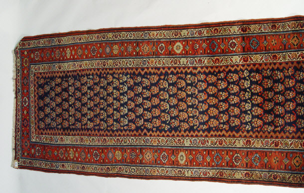 Appraisal: Iranian rectangular carpet runner decorated with a geometric red and