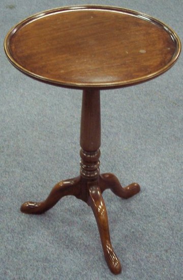 Appraisal: A circular mahogany table raised on a turned column and