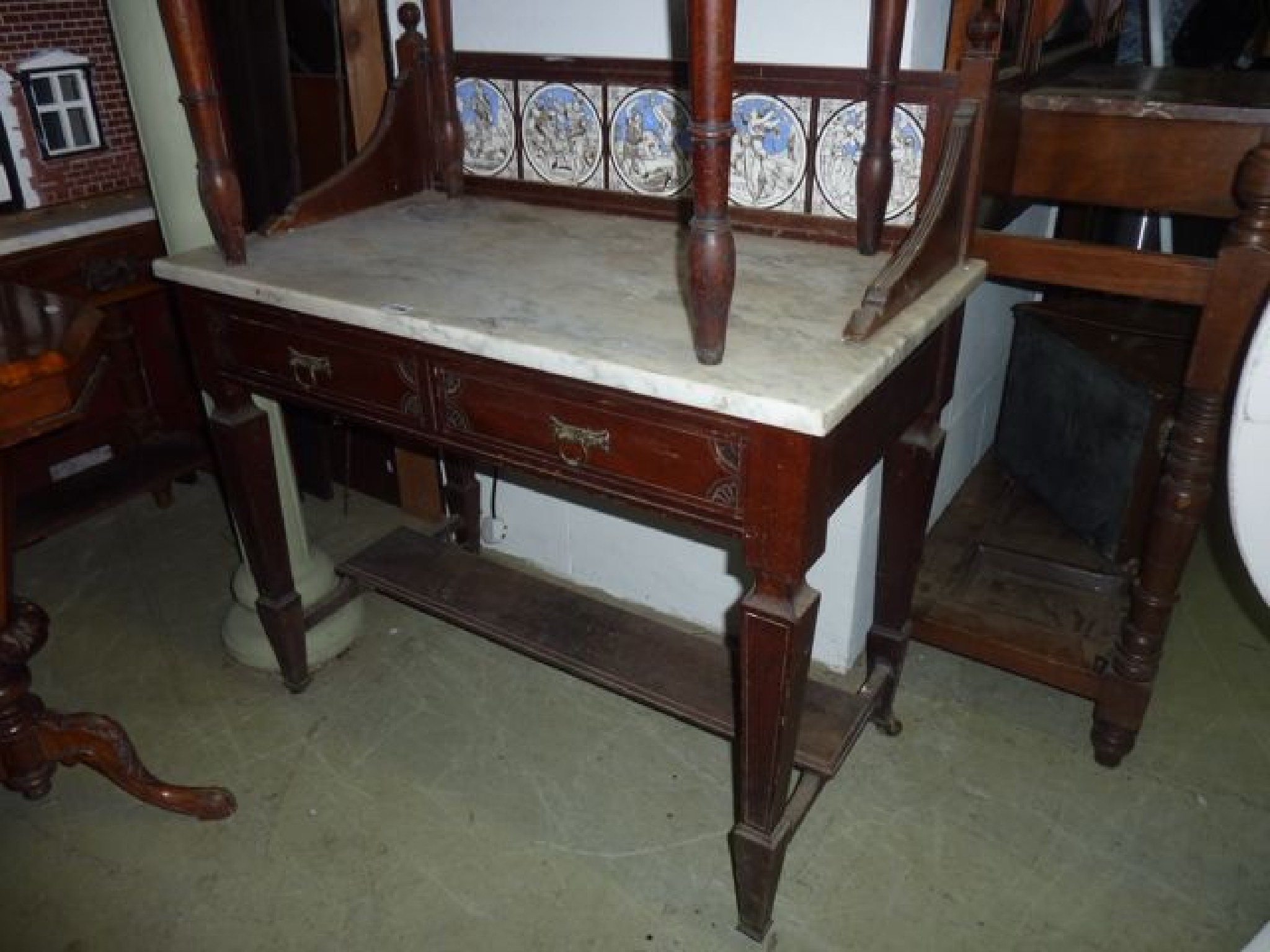 Appraisal: A late Victorian mahogany marble top washstand the raised splashback