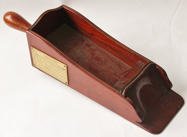 Appraisal: AN OLD MAHOGANY CASINO CARD SHOE with turned handle and