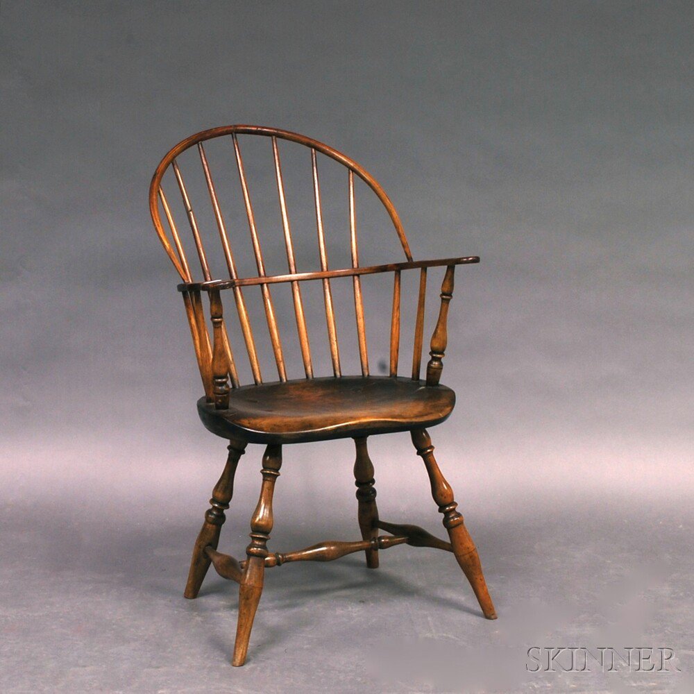 Appraisal: Sack-back Windsor Chair New England th century with carved handholds