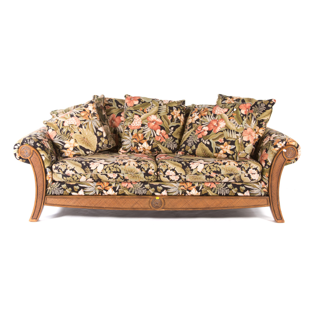 Appraisal: Contemporary floral upholstered sofa stained and partially caned wood in