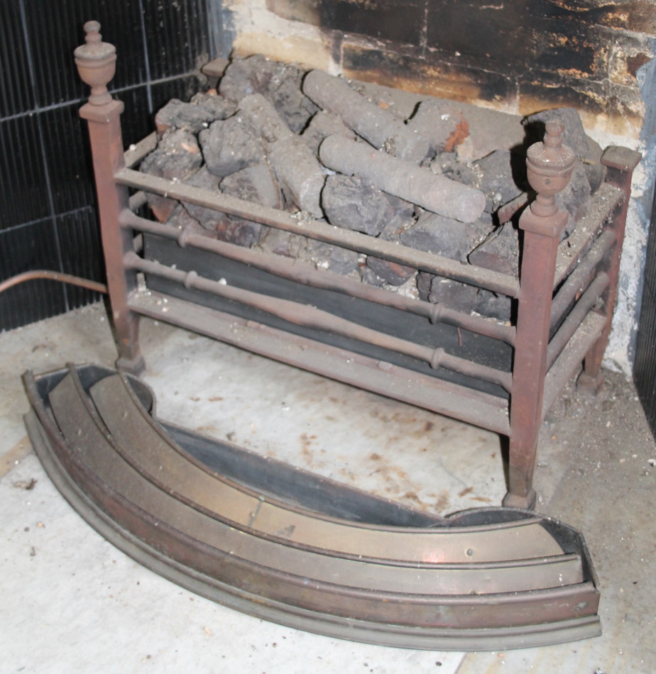 Appraisal: A cast iron fire grate with urn finials on tapering