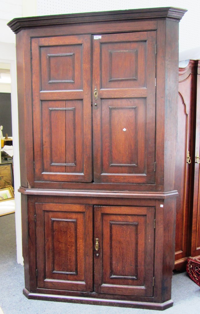 Appraisal: A large George III oak double height floor standing corner