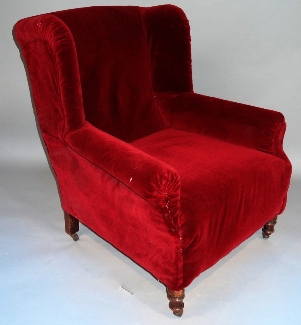 Appraisal: A Victorian mahogany framed wing armchair in crimson material raised