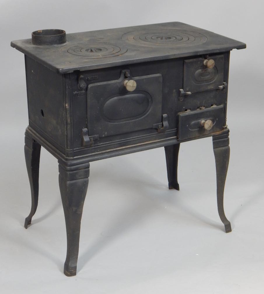 Appraisal: A Continental cast iron stove with an arrangement of drawers