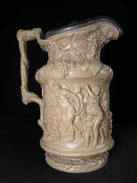 Appraisal: An impressive English ceramic ewer with high relieve Bacchic scene