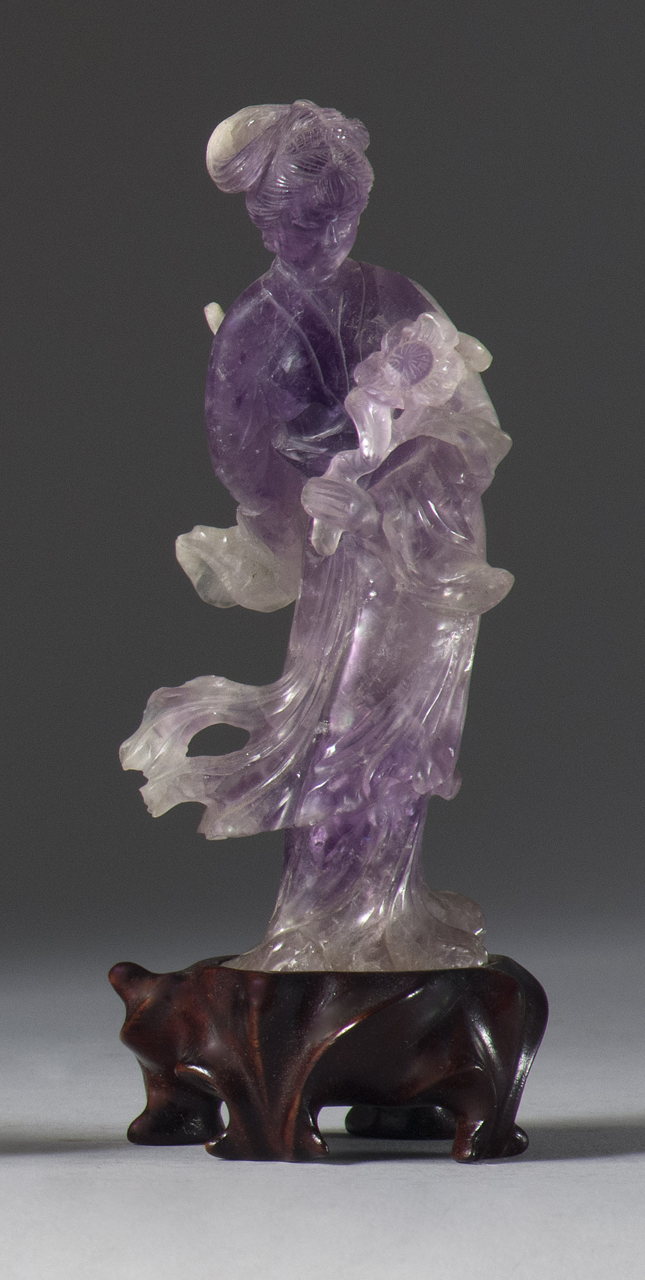 Appraisal: AMETHYST CARVING OF GUANYIN th CenturyStanding with a lotus blossom