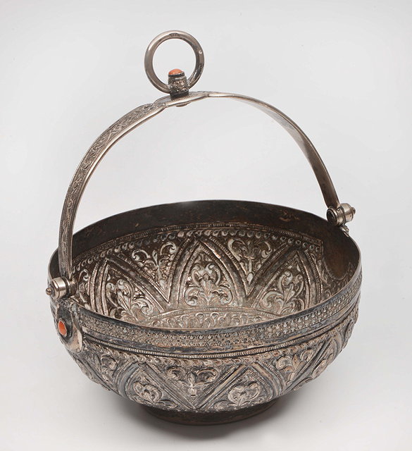 Appraisal: A MIDDLE EASTERN WHITE METAL BOWL with looping handle and