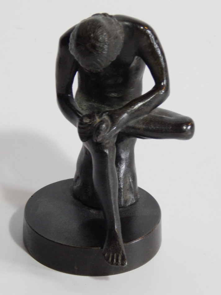 Appraisal: A small bronze classical figure of a seated youth extracting