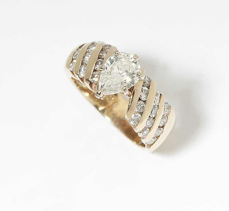 Appraisal: A pear-shaped diamond and gold ring K gold centering a