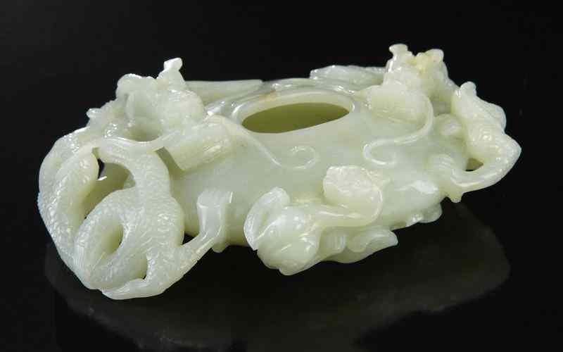 Appraisal: Chinese carved jade brush washer depicting three dragons ''L Circa