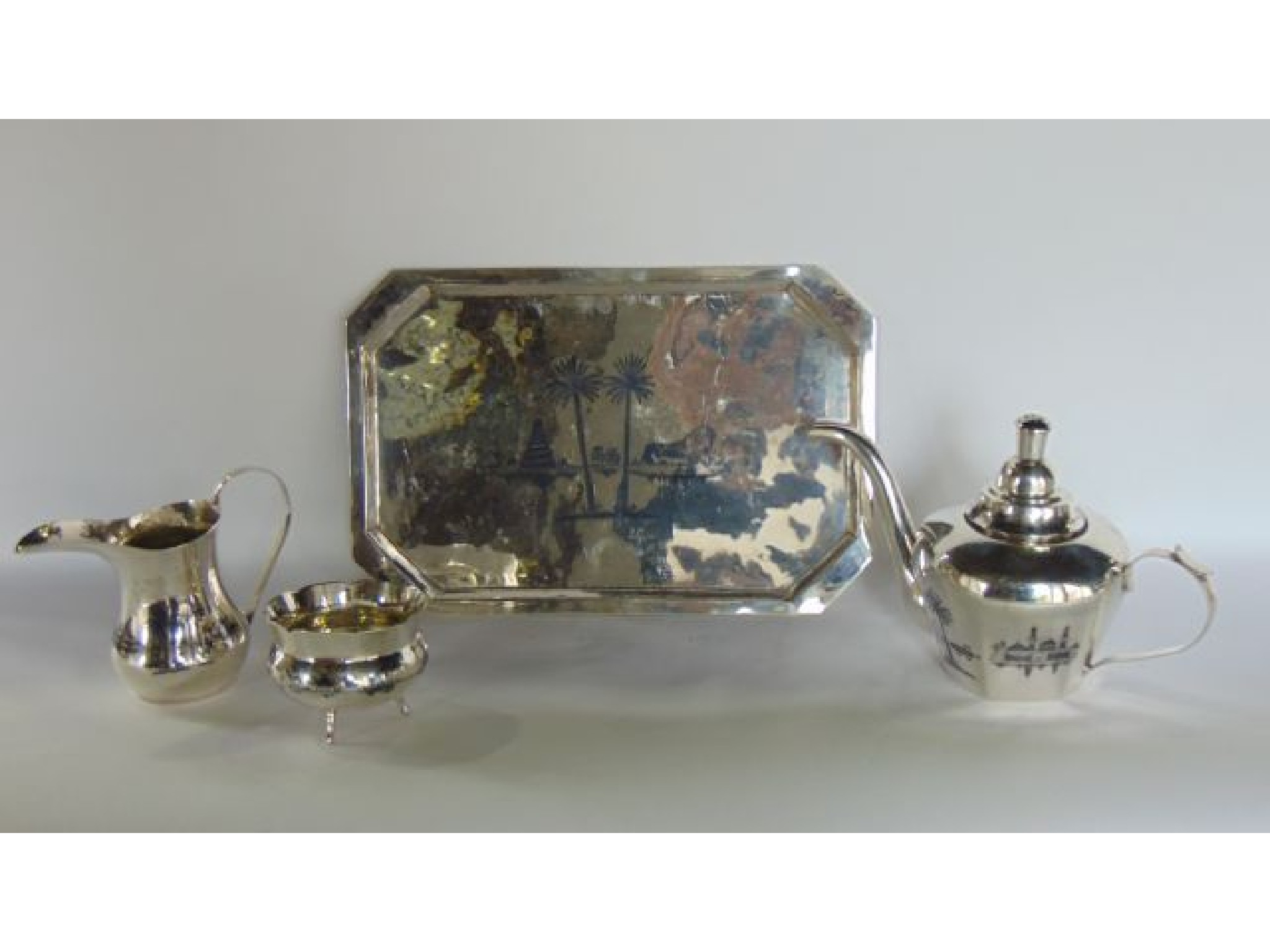 Appraisal: A white metal Middle Eastern tea service comprising a teapot