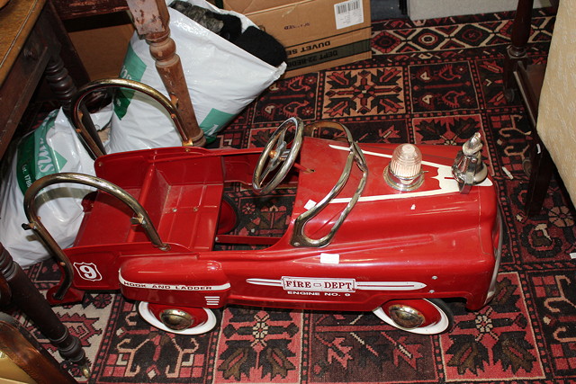 Appraisal: A RED PAINTED TIN CHILD'S PEDAL CAR in the form