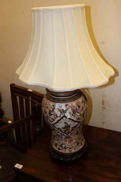 Appraisal: A JAPANESE IMARI TABLE LAMP standing on a carved wooden