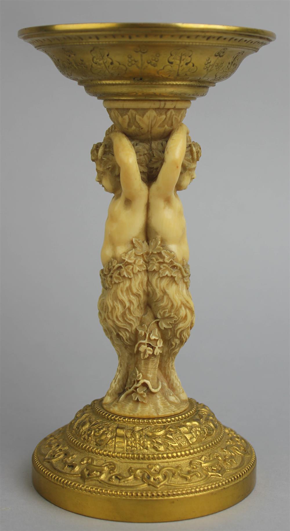 Appraisal: IVORY AND GILT BRONZE STAND WITH SATYRS th Century the